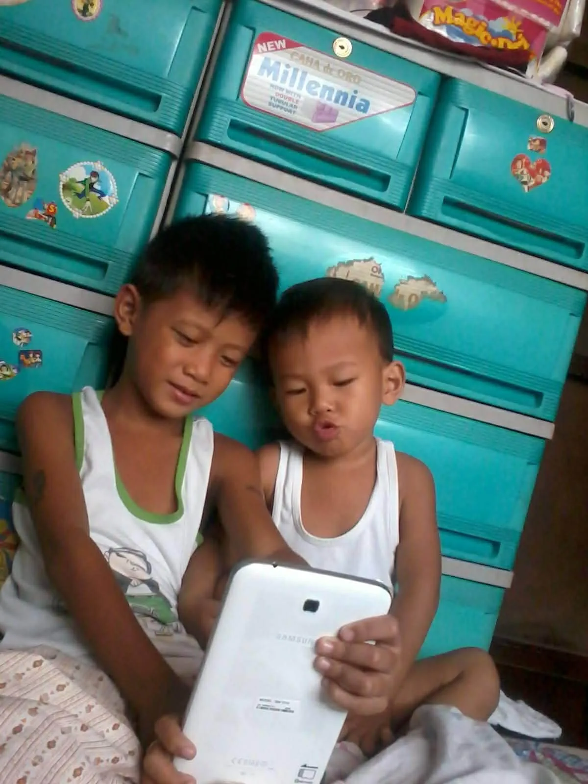 Two young brothers sharing a tablet